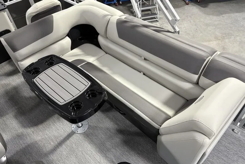Slide: The Image of 2026 Sun Tracker Fishin' Barge 22 XP3 interior with cushioned seating and table. - 23