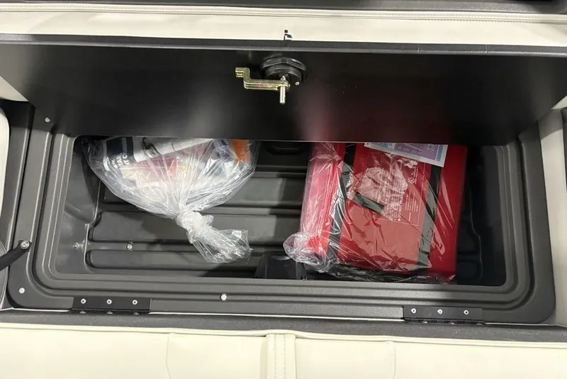 Slide: The Image of Storage compartment in 2026 Sun Tracker Fishin' Barge 22 XP3, containing packaged items. - 30