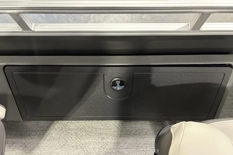 Slide: The Image of 2026 Sun Tracker Fishin' Barge 22 XP3 storage compartment with lock, interior view. - 31