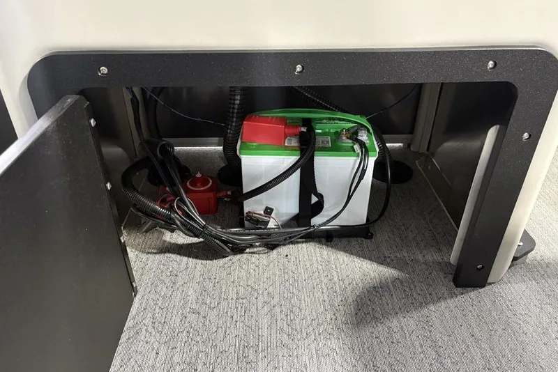 Slide: The Image of Battery compartment of 2026 Sun Tracker Fishin' Barge 22 XP3, featuring wiring and connections. - 32