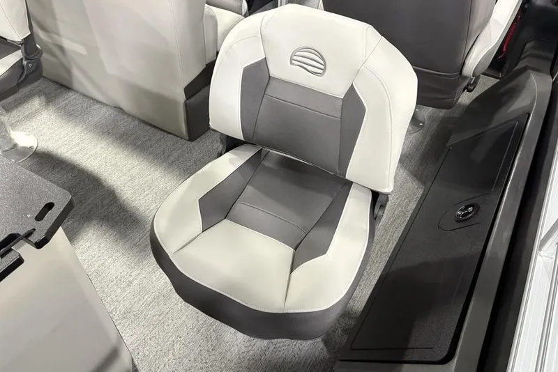 Slide: The Image of 2026 Sun Tracker Fishin' Barge 22 XP3 seat, gray and white design, on carpeted floor. - 36