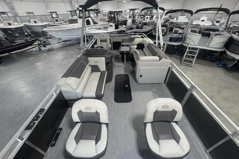Slide: The Image of 2026 Sun Tracker Fishin' Barge 22 XP3 interior with spacious seating in a showroom. - 38