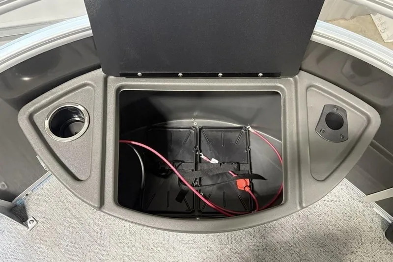 Slide: The Image of 2026 Sun Tracker Fishin' Barge 22 XP3 storage compartment with cup holder and wiring. - 7