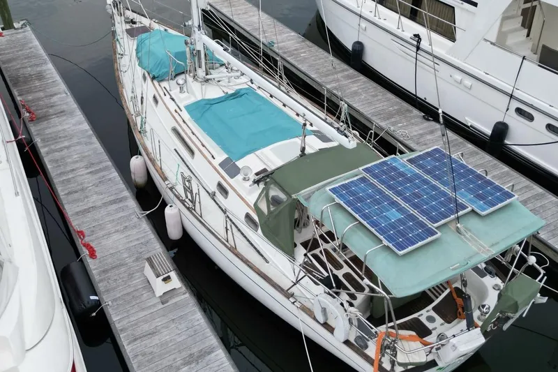 Slide: The Image of Sailboat docked with solar panels, Passport 47 model, 1985, aerial view. - 1
