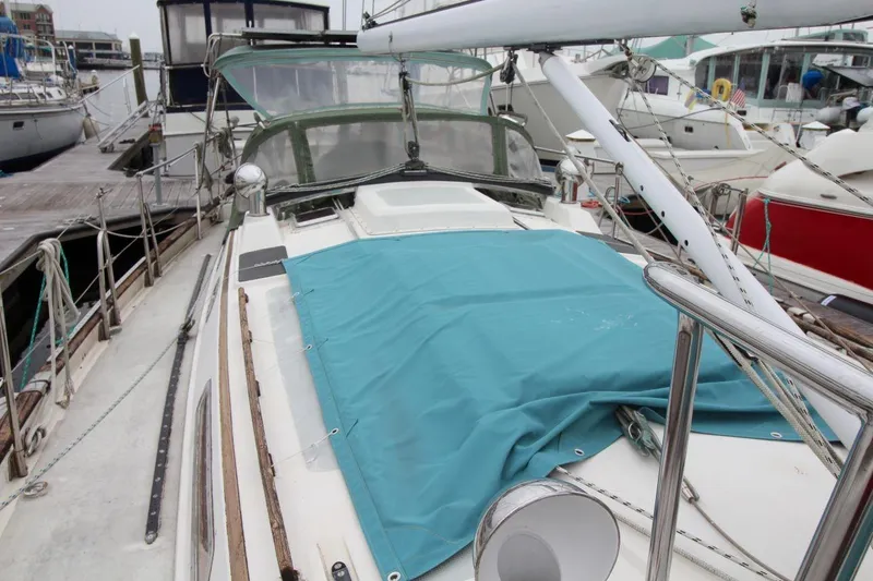 Slide: The Image of Sailboat docked at marina, Passport 47 model, 1985, with blue cover on deck. - 10