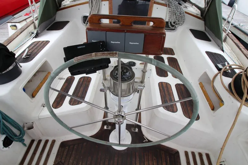 Slide: The Image of Cockpit of 1985 Passport 47 sailboat with steering wheel and navigation equipment. - 15