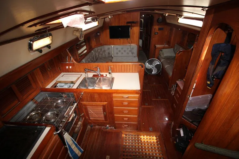 Slide: The Image of Interior of 1985 Passport 47 yacht with wooden cabinetry and modern amenities. - 16