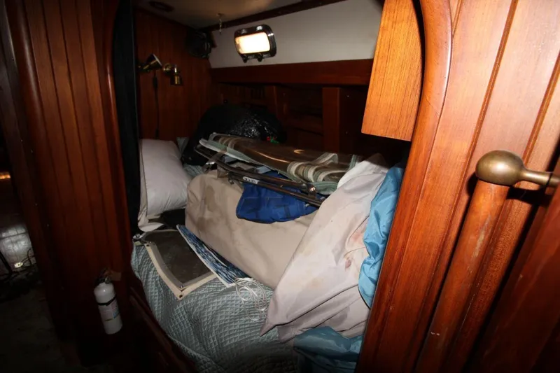 Slide: The Image of Interior of a 1985 Passport 47 sailboat with cluttered cabin space. - 23