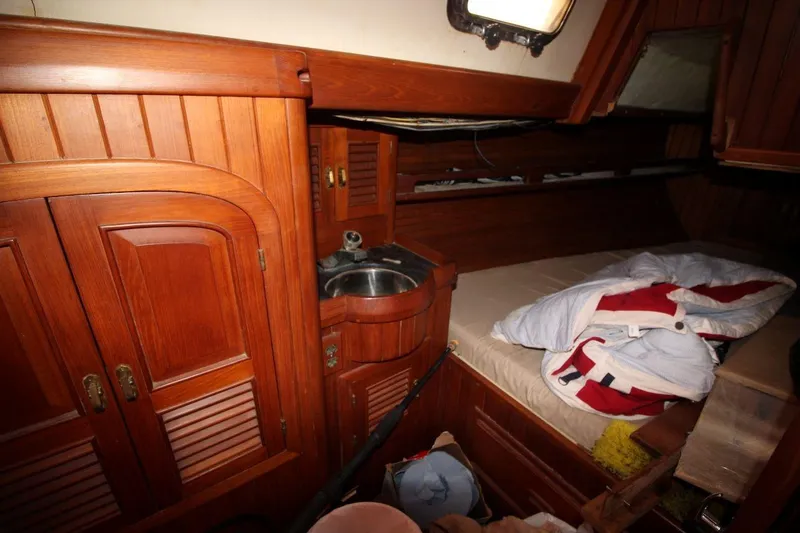 Slide: The Image of Cozy 1985 Passport 47 yacht cabin with wooden interior and compact sink. - 26