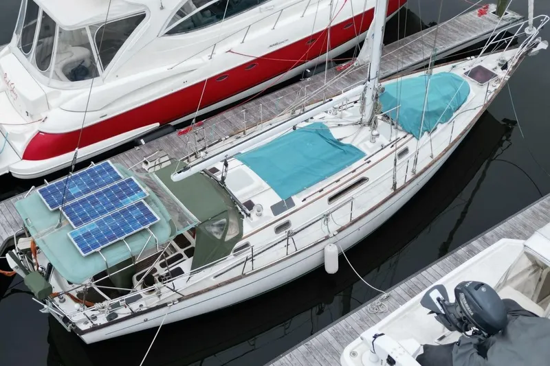 Slide: The Image of Aerial view of 1985 Passport 47 sailboat with solar panels docked at marina. - 7