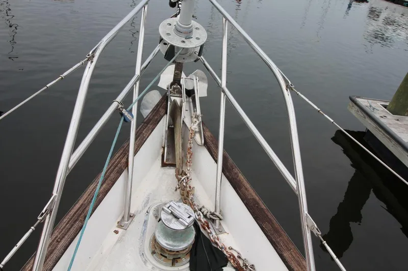 Slide: The Image of Bow of 1985 Passport 47 sailboat with anchor chain and calm water. - 9