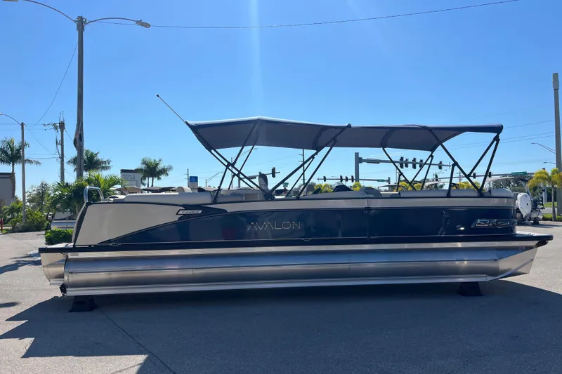 Slide: The Image of 2026 Avalon 2785 Catalina Bar Tri Toon boat with Mercury 400hp V-10 engine, parked outdoors. - 4