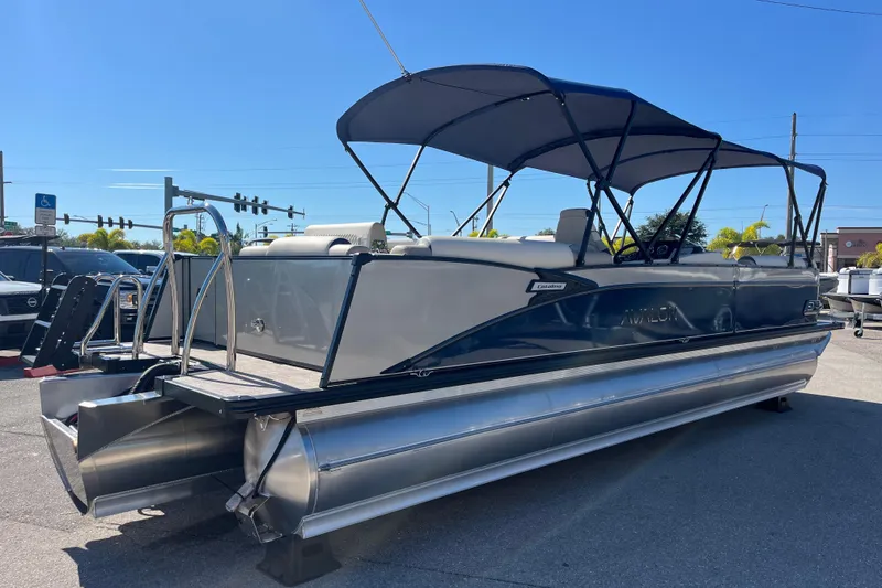 Slide: The Image of 2026 Avalon 2785 Catalina Bar Tri Toon boat with Mercury 400hp V-10 engine, parked outdoors. - 5
