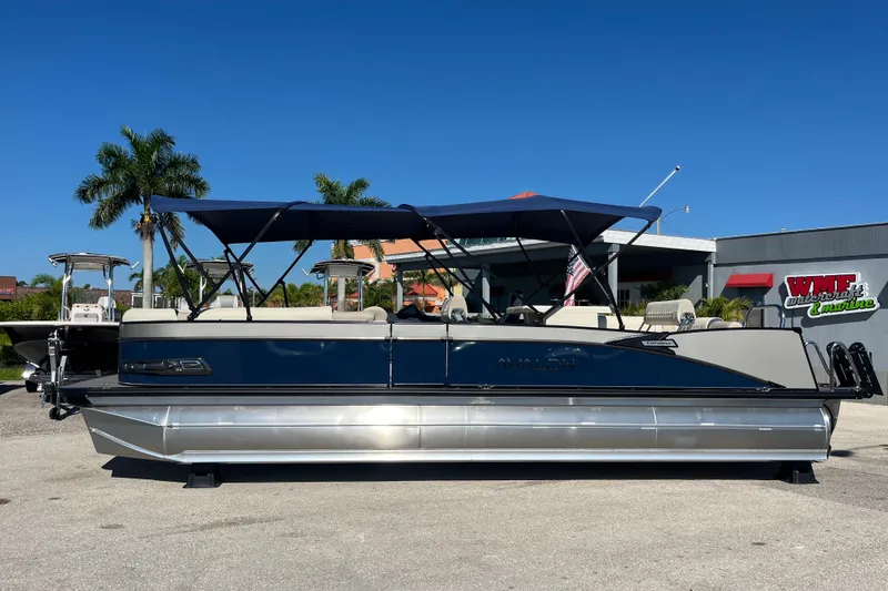 Slide: The Image of 2026 Avalon 2785 Catalina Bar Tri Toon boat with Mercury 400hp V-10 engine, parked outdoors. - 8