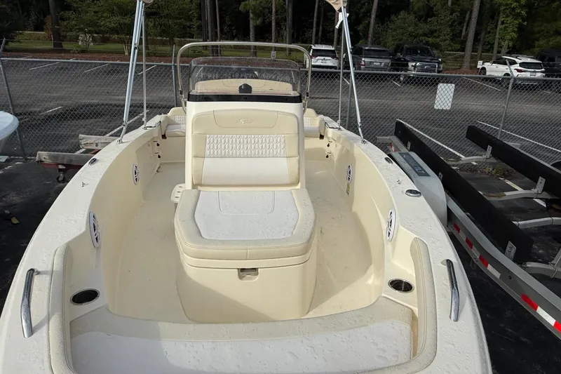 Slide: The Image of 2026 Scout 188 Sportfish boat with beige interior, parked in a lot. - 17