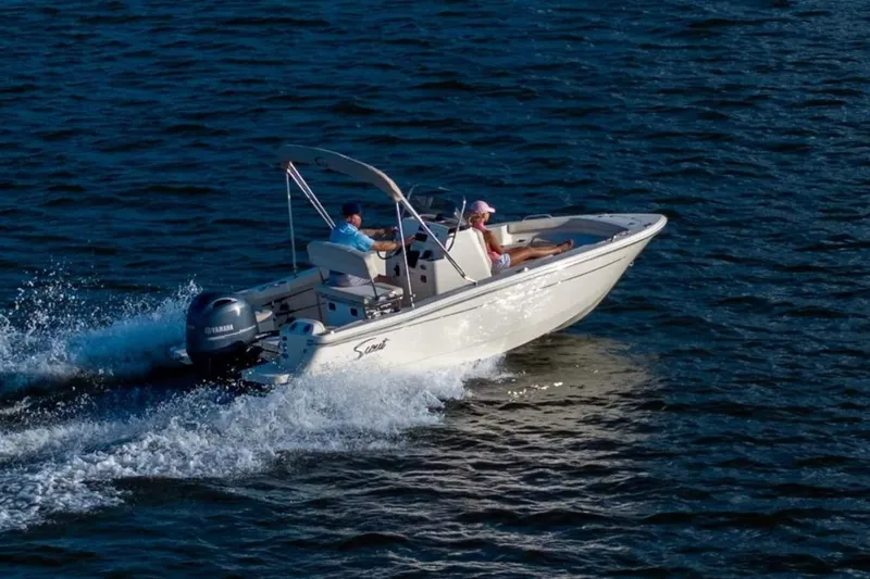 Slide: The Image of 2026 Scout 188 Sportfish boat cruising on open water. - 2