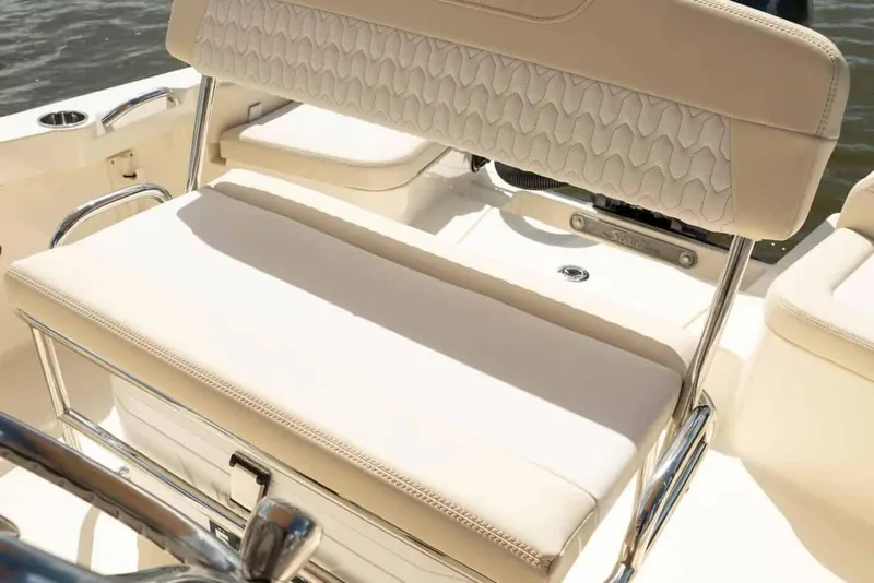 Slide: The Image of 2026 Scout 188 Sportfish boat interior with beige seating and stainless steel accents. - 9