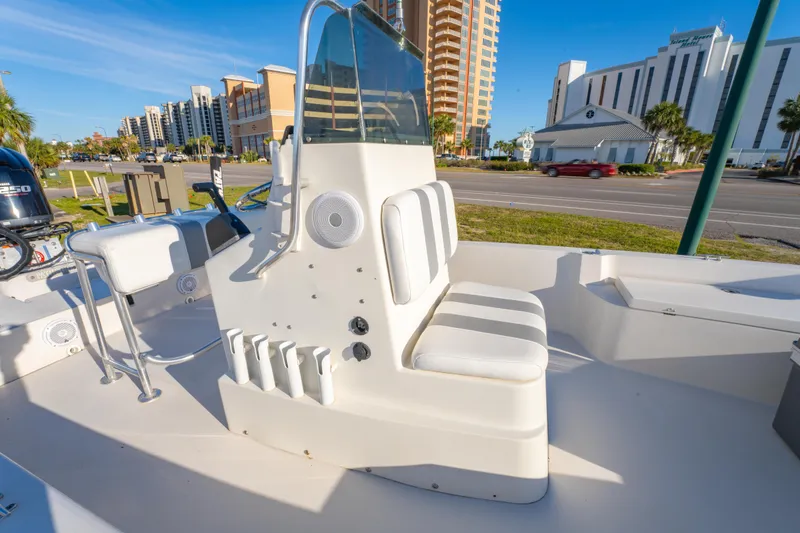 Slide: The Image of 2001 Pathfinder 2400-V boat interior with seating, console, and cityscape background. - 13