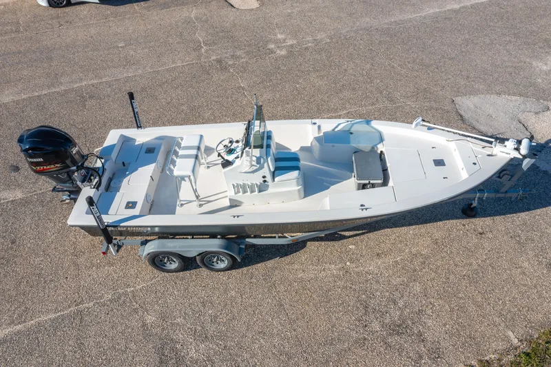 Slide: The Image of 2001 Pathfinder 2400-V boat on trailer, aerial view, parked on concrete surface. - 21