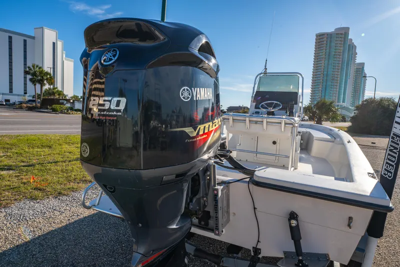 Slide: The Image of 2001 Pathfinder 2400-V boat with Yamaha 250 VMAX engine, parked near modern buildings. - 5