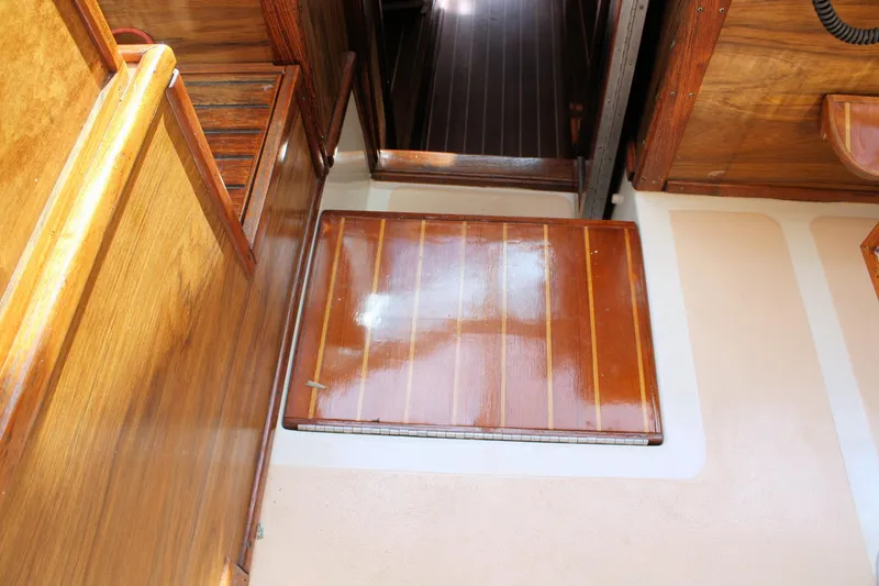 Slide: The Image of Interior of 1980 Sea Ray 300 Weekender, featuring polished wooden flooring and cabinetry. - 10