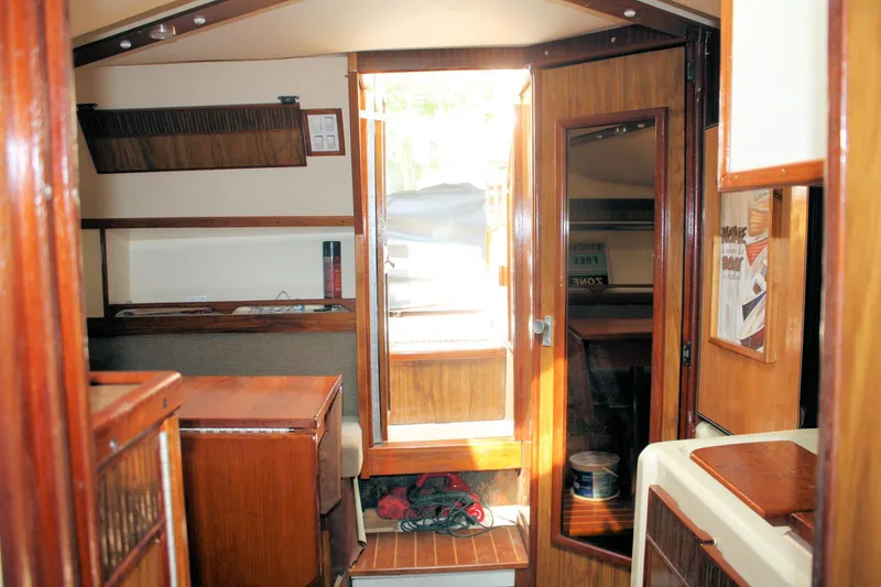 Slide: The Image of Interior of a 1980 Sea Ray 300 Weekender boat with wooden furnishings. - 15