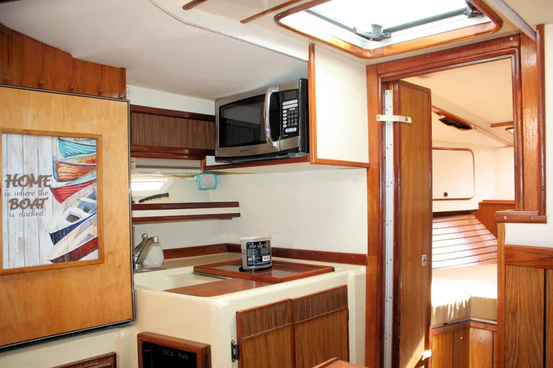 Slide: The Image of Interior of 1980 Sea Ray 300 Weekender boat with kitchenette and cozy cabin. - 16