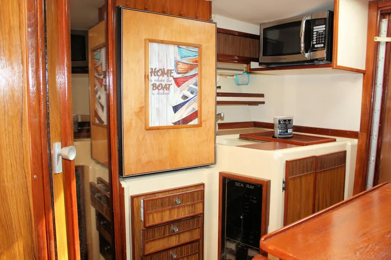 Slide: The Image of Interior of 1980 Sea Ray 300 Weekender boat with wood cabinetry and microwave. - 17