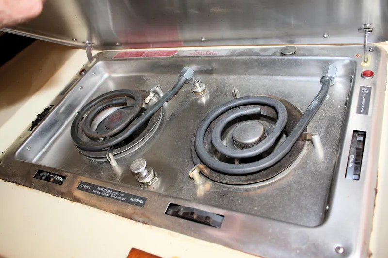 Slide: The Image of 1980 Sea Ray 300 Weekender stove with dual electric burners and control panel. - 18