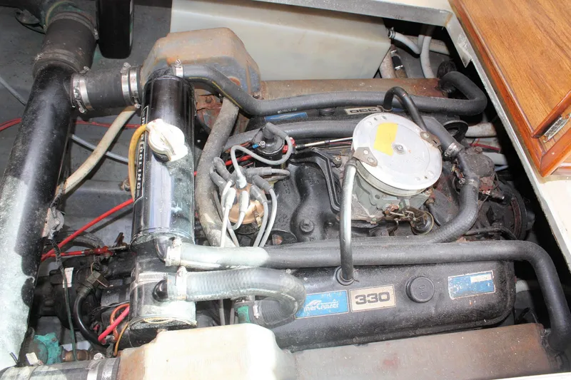 Slide: The Image of Engine compartment of a 1980 Sea Ray 300 Weekender boat, featuring a MerCruiser 330 engine. - 24