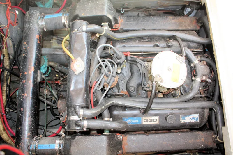 Slide: The Image of Engine of a 1980 Sea Ray 300 Weekender boat, showing detailed components and wiring. - 25
