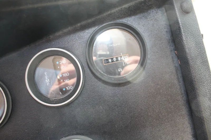 Slide: The Image of Dashboard gauges of a 1980 Sea Ray 300 Weekender boat, showing temperature and hours. - 26