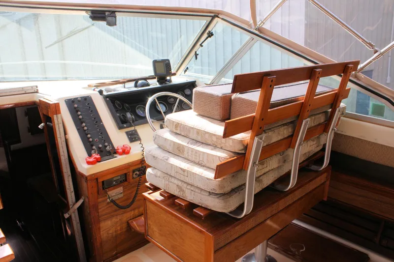 Slide: The Image of 1980 Sea Ray 300 Weekender helm with wooden seating and control panel. - 6