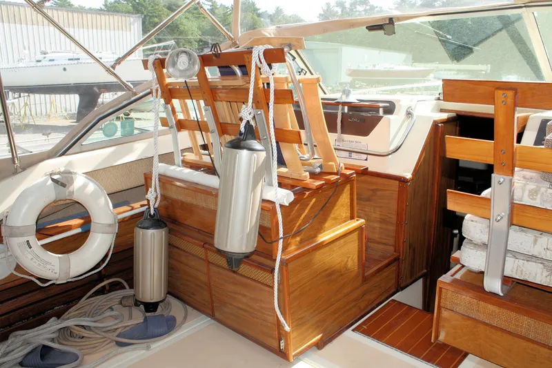 Slide: The Image of 1980 Sea Ray 300 Weekender boat interior with wooden accents and nautical equipment. - 7