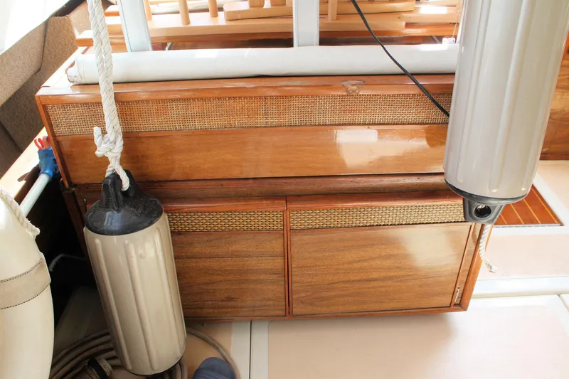 Slide: The Image of 1980 Sea Ray 300 Weekender interior with wooden cabinetry and boat fenders. - 8