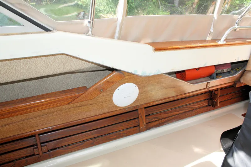 Slide: The Image of 1980 Sea Ray 300 Weekender interior with wood paneling and storage compartment. - 9