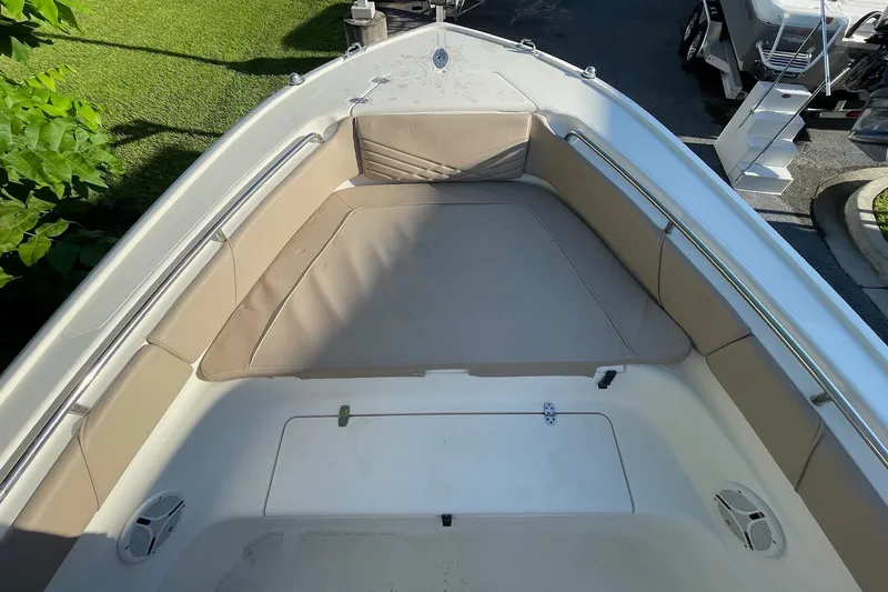 Slide: The Image of 2006 Scout 242 Sportfish boat with cushioned seating and storage area. - 12