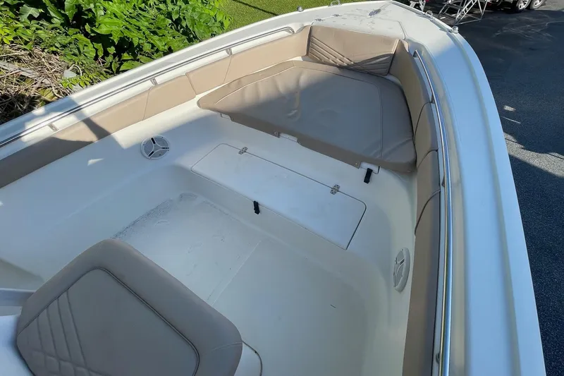 Slide: The Image of 2006 Scout 242 Sportfish boat interior with cushioned seating and storage compartment. - 13
