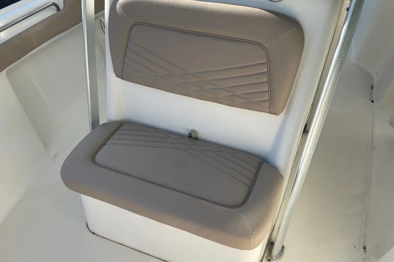 Slide: The Image of 2006 Scout 242 Sportfish boat seat with beige upholstery and metal frame. - 15