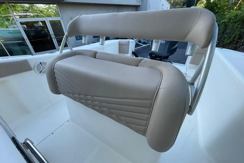 Slide: The Image of 2006 Scout 242 Sportfish boat seat with beige upholstery and stainless steel frame. - 16