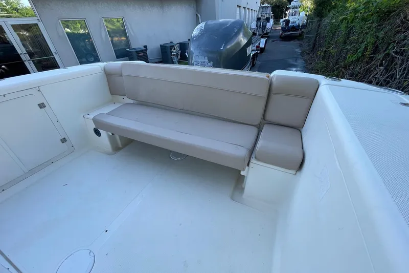 Slide: The Image of 2006 Scout 242 Sportfish boat interior with beige seating and storage compartments. - 17