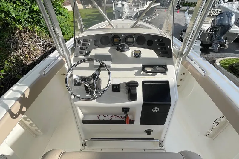 Slide: The Image of 2006 Scout 242 Sportfish boat console with steering wheel and controls. - 18