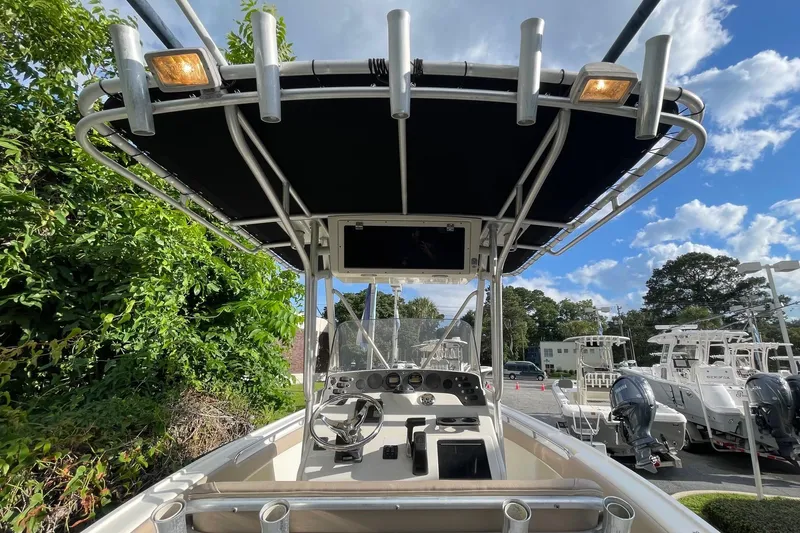 Slide: The Image of 2006 Scout 242 Sportfish boat cockpit with T-top and steering console. - 19
