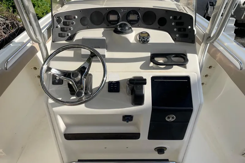 Slide: The Image of 2006 Scout 242 Sportfish boat dashboard with steering wheel and control panel. - 20