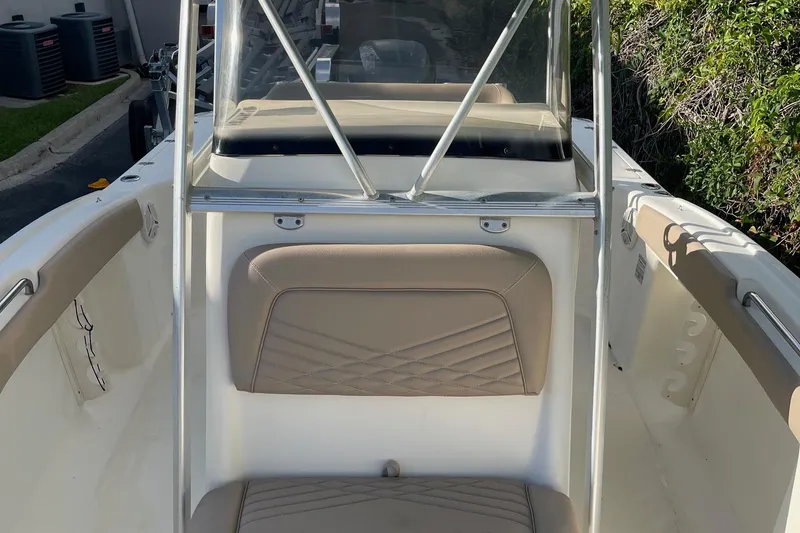 Slide: The Image of 2006 Scout 242 Sportfish boat interior with beige seating and windshield. - 25