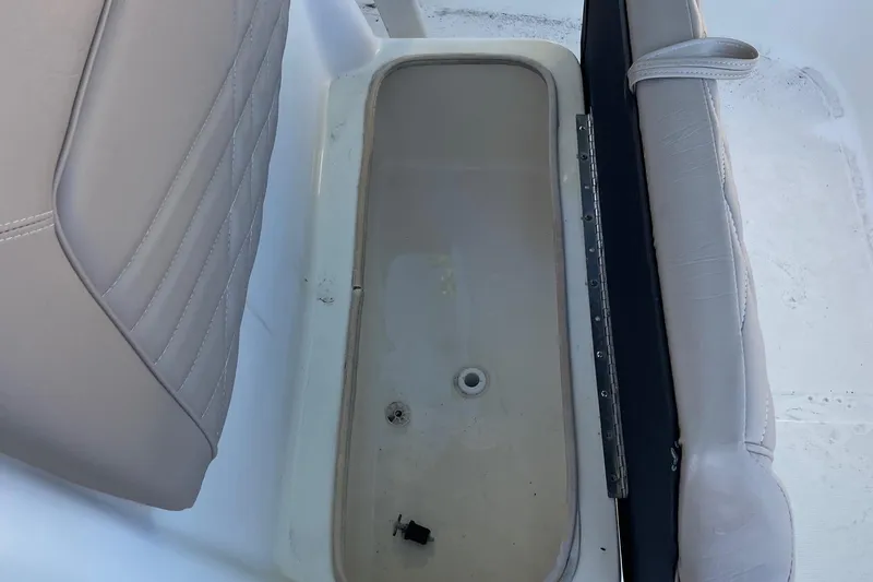 Slide: The Image of 2006 Scout 242 Sportfish boat seat with storage compartment open. - 26