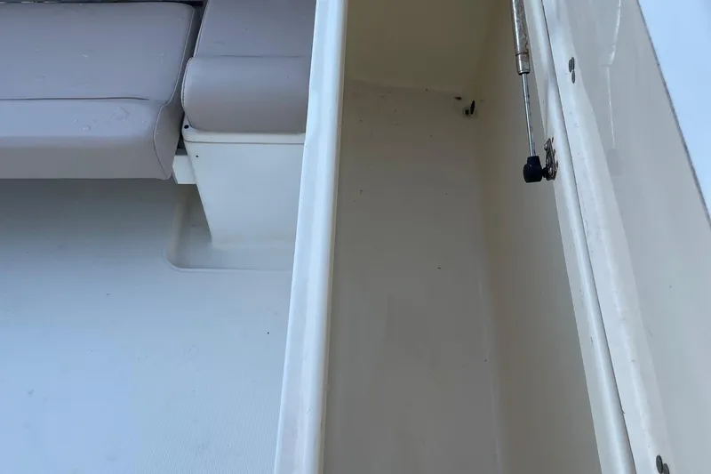 Slide: The Image of 2006 Scout 242 Sportfish interior storage compartment with cushioned seating. - 28