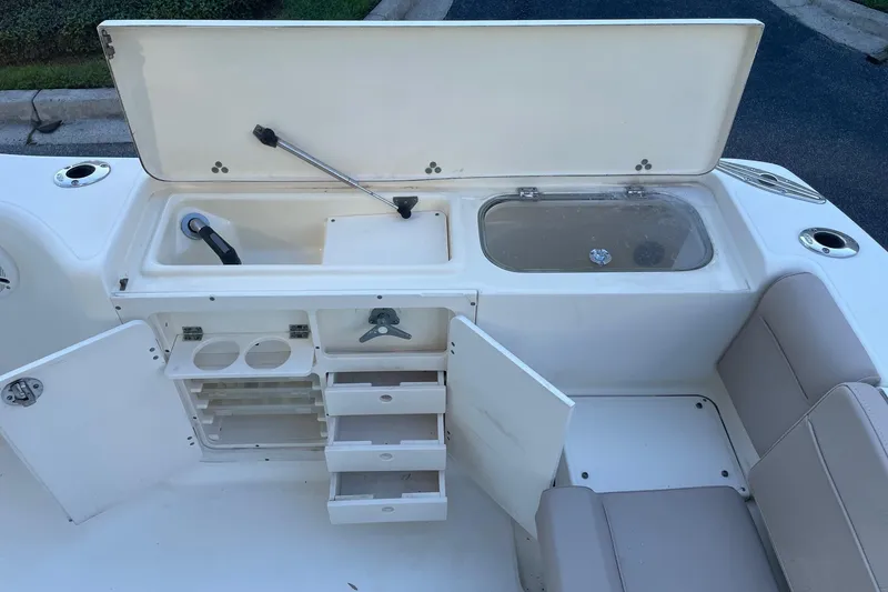 Slide: The Image of 2006 Scout 242 Sportfish boat interior with storage compartments and seating. - 33