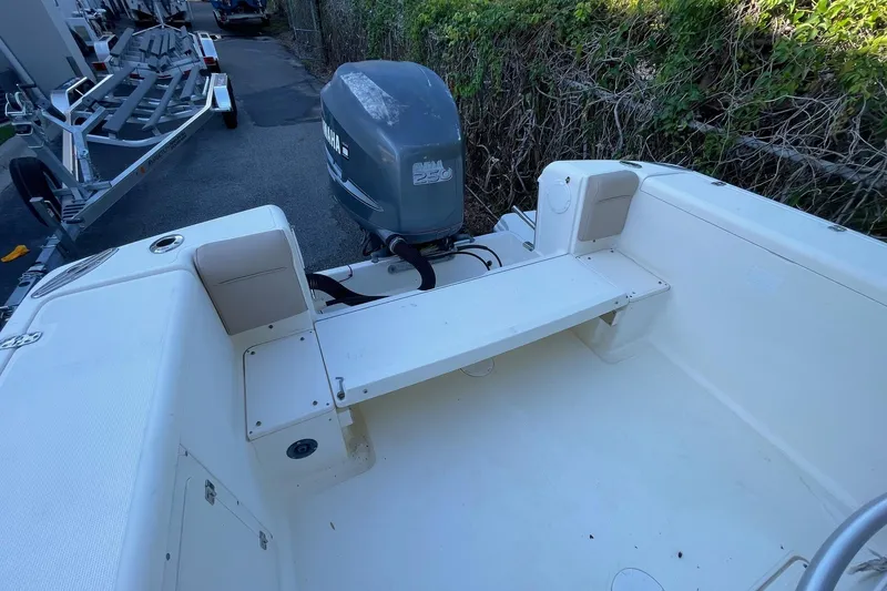 Slide: The Image of 2006 Scout 242 Sportfish boat with Yamaha 250 outboard motor, parked near trailers. - 36