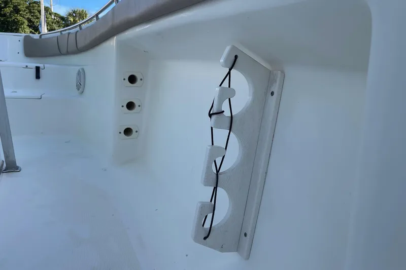 Slide: The Image of 2006 Scout 242 Sportfish boat interior with rod holders and storage features. - 39